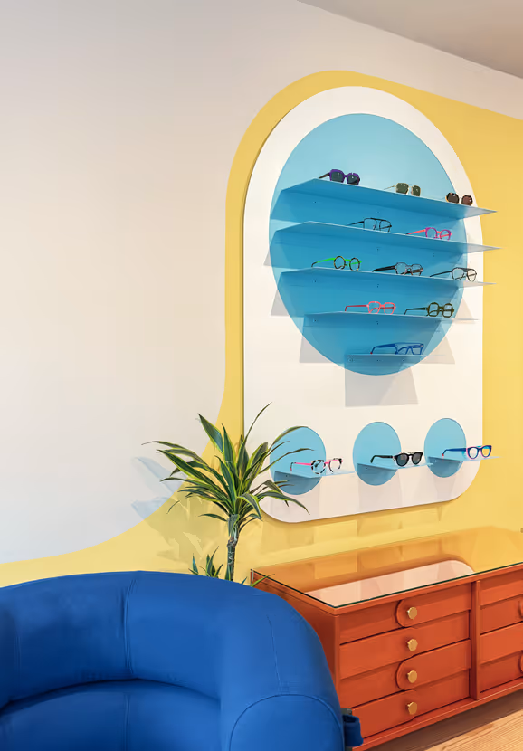 Opticians - Glasses on shelf on wall - blue circle